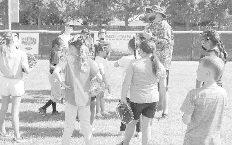 ATTENTION - Levelland coach Ryan Miller gets his girls attention to show them what he want and how he wants it at the Levlland Softball Camp Monday morning at Loboette Ballpark. (Staff Photo by Aalijah Soliz)