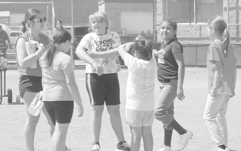 MENTOR - 2023 Graduate Maddie Rico helped out the youth campers by talking to them about what they needed to learn at the annual softball camp. The Loboette Softball Camp kicked-off Monday morning and concluded Tuesday. The camp was led by head coach ryan Millers. (Staff Photo by Aalijah Soliz)