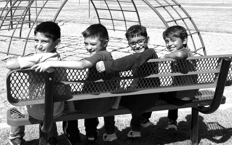 NEWEQUIPMENT– The Capitol Elementary Parent Club purchased a new playground bench for the west playground at Capitol. Staff and students will now have a place to rest during break and playtime. Pictured from the left are: Sergio Vidales, Zachariah Castillo, Aiden Garcia and Mathew Flores. (Submitted Photo)