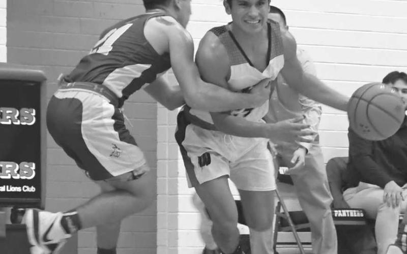 PHYSICAL - Panther Nomar Gomez tried to get past Whiteface’s Noah Rendon in a 45-34 home win for the Whitharral Panthers in UIL District 7-1A High School Boys’ Basketball action on January 9. The Panthers will be in Meadow on Friday at 7:30 p.m. while Whiteface travels to Morton for an 8 p.m. game. (Photo by Keegan Edwards)