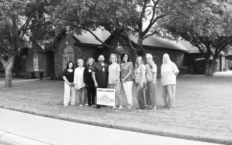 YARD OF THE MONTH - George and Gena Mesquias were awarded Yard of the Month. The yard was mowed with a line pattern, trees were clipped and trimmed, the bushes neatly in a row and grass was so green. Pictured from left to right are: Arra Delos Santos, Barbra Pinner, Angie Yandell, George Mesquias, Gena Mesquias, Cristal Isaacks, Jessica Vinson and Donna Wheeler. (Staff Photo by Hannah Woodrum)