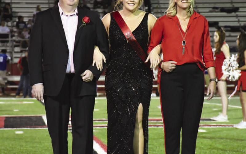 HOMECOMINGQUEEN - Levelland High School held their Homecoming last week during the Lobos vs. Estacado football game on Friday. Announced as Homecoming Queen at halftime, senior Laci White was escorted by her parents Bruce and Terry White. (Staff Photo by Dominick Puente)