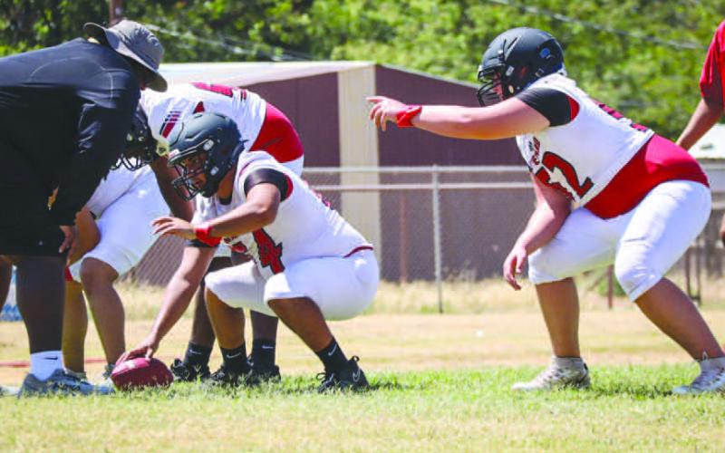 COMMUNICATION - Levelland Lobos Casen Potter and Zarian Valderas talked about their blocking assignments during team drills this past Monday during two-a-days. (Staff photo by Aalijah Soliz)