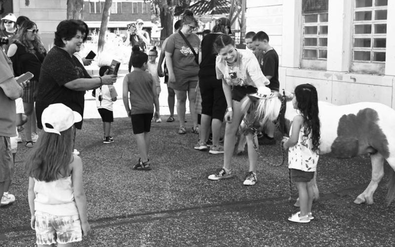 MINI HORSING AROUND - The Hockley County Library summer reading program held an event Wednesday on the downtown square in Levelland. The event included three mini horses named Cracker Jack, Buttercup and Snuggles. The mini horses were brough to the square courtesy of Minis and Friends South Plains which is a non-profit equine guided interaction organization dedicated to sharing the love and spirit of mini horses. (Staff Photo by Victoria Byrnes)