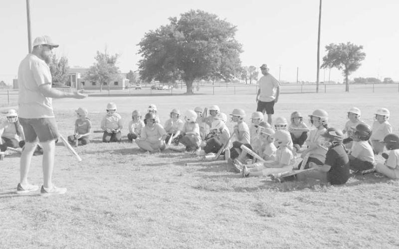 PAYING ATTENTION - The Levelland Youth Softball League held a summer camp at the Levelland City Park, June 23-24. The camp consisted of covering all the fundamentals with the game of softball and working on several drills to better their skills. Pictured is Youth League President Jacob Tucker speaking to the kids in attendance and instructors on what the camp covered and the importance of all the drills. (Staff Photo by Aalijah Soliz.)