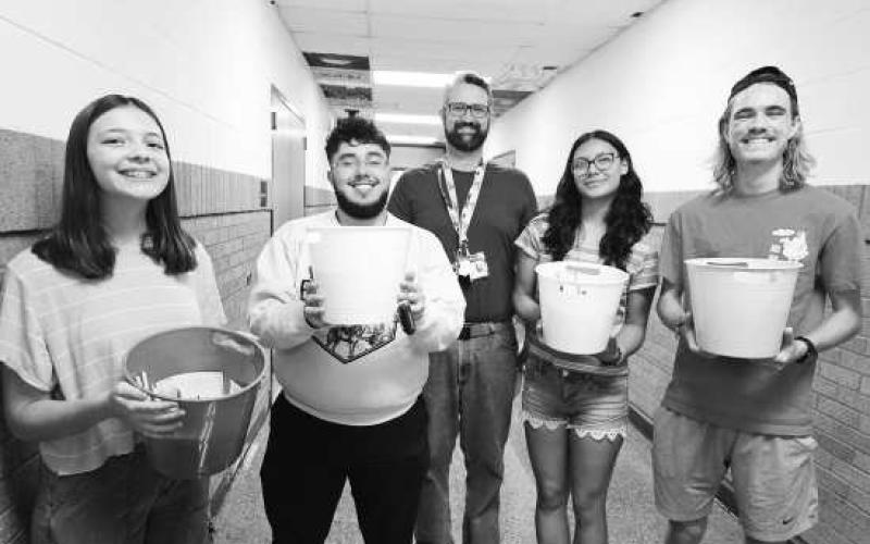 STUCO GIVES BACK - LHS Student Council members welcomed back new LHS teachers on campus with survival buckets. The survival buckets include pens, band-aids, sticky notes, aspirin and more items for the upcoming year. Pictured from left to right are: Melody Demel, Alvaro Loza, Student Council Sponsor Scott Lawson, Amor Gabaldon and Ryan Jeanneret. (Photo courtesy of LHS)