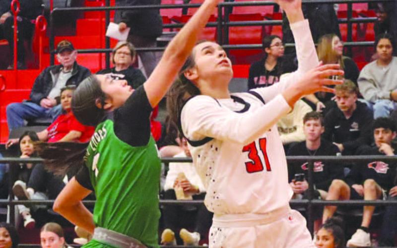 Levelland Loboette Leilani Sanchez layed the ball up through contact during the teams contest against the Monahans Lady Loboes. (Staff photo by Aalijah Soliz)