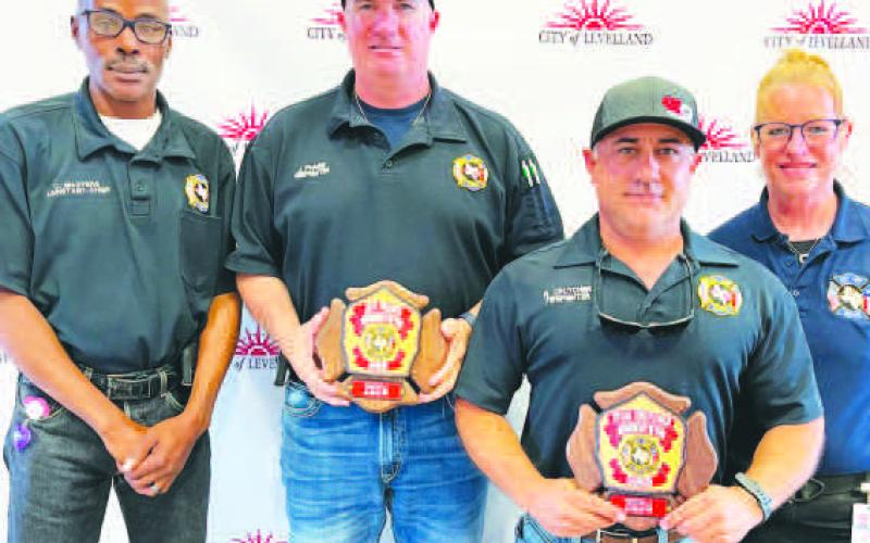 WAY TO GO - Jeff Pharis and Ryan Crutcher were each awarded the Career - Firefighter of the Year Award at the LFD awards banquet held on Saturday. Pictured from right to left are: Curt Masters, Jeff Pharis, Ryan Crutcher and Patty Byars - Faulkner. (Photo courtesy of the LFD)