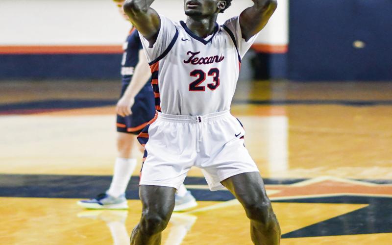 PUT YOUR LEGS INTO IT - South Plains College sophomore center Alexandre K’Medehouto squats down to shoot a free throw during their game against Snow College this past Thursday night at the Texan Dome. K’Medehouto is seven feet tall. (Staff photo by Jentezen Smith)