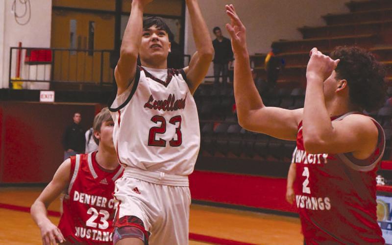 TOUGH FLOATER- Levelland Lobos earned a 52-46 road win over the Plainview Bulldogs. The win moved the Lobos to 10-10 with one game left to play before district competition kicks offs. Lobo Zameron Lecroy put up a floater in between defenders during a Lobos home win against Denver City last month. (Staff Photo by Dom Puente)