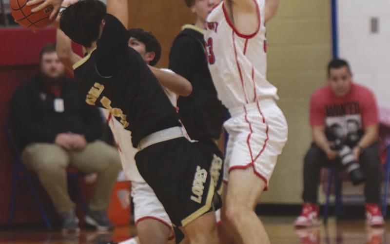 STIFLING DEFENSE- The Sundown Roughnecks (3-5) hosted Post (0-11) for in their district opener at home and took a 64-38. Stifling defense from Roughnecks Adan Escamilla and Watson Evans slowed the Post offense. (Photo Courtesy of Chris Bratcher)