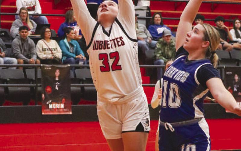 FINISH STRONG - Levelland Loboette Emery Smith finished the play through the contact during the team’s game against the Maidens at home during their district opener. (Staff photo by Aalijah Soliz)