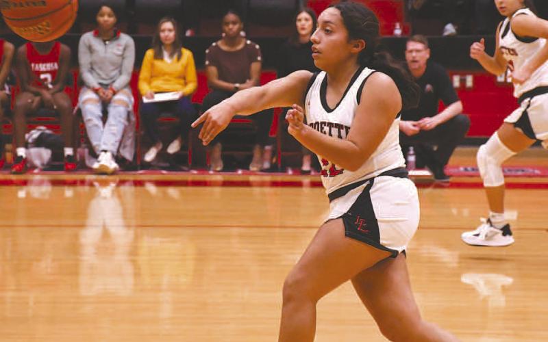 BREAK STARTER- The fifth ranked Levelland Loboettes rolled out the welcome mat for the 15th ranked Tacosa Lady Rebels Friday. Loboette Olivia Velardez kicked the ball up the court to start a fast-break. (Staff Photo by Dom Puente)