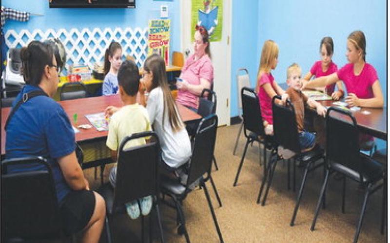BOARD GAMES INDOORS – Pictured are kids having fun playing classic board games on Wednesday. The library’s summer reading activity featured Sorry, Connect 4, Chutes and Ladders, Candyland and more. (Staff photo by Ada Niederhauser)