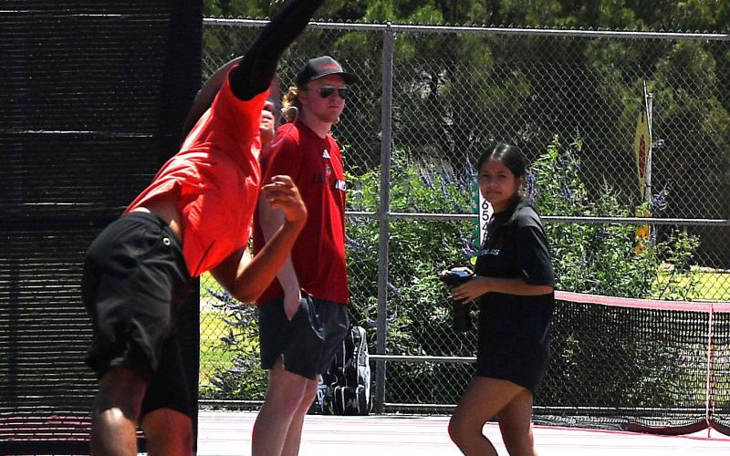 LHS Home Tennis Match - LHS senior Diego Franco gets high while delivering a powerful overhead serve during the first Levelland home tennis match of the season. (Staff photo by Trinity Boudreaux)