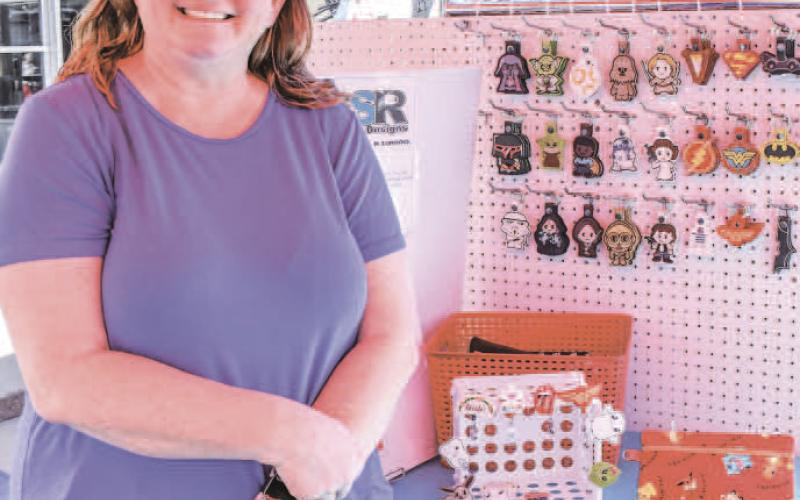 KEYCHAIN SALE – Dana Reddell sold keychains among other items at Saturday’s Falling for the Wallace festival in downtown Levelland. The tent was one of many set up next to Houston Street’s storefronts, which were open to attendees of the event for shopping. (Staff photo by Evin Thomas)