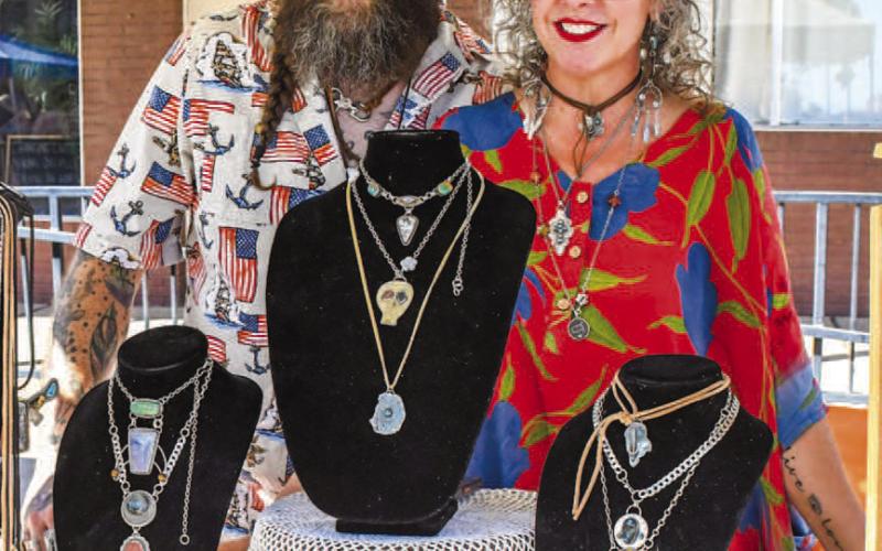 JEWELRY ON DISPLAY – BJ Smith and Aliciaa McDonald smiled under their tent at downtown Levelland’s Falling for the Wallace festival on Saturday. They were one of many sellers set up along Houston Street, showing accessories to event attendees. (Staff photo by Evin Thomas)
