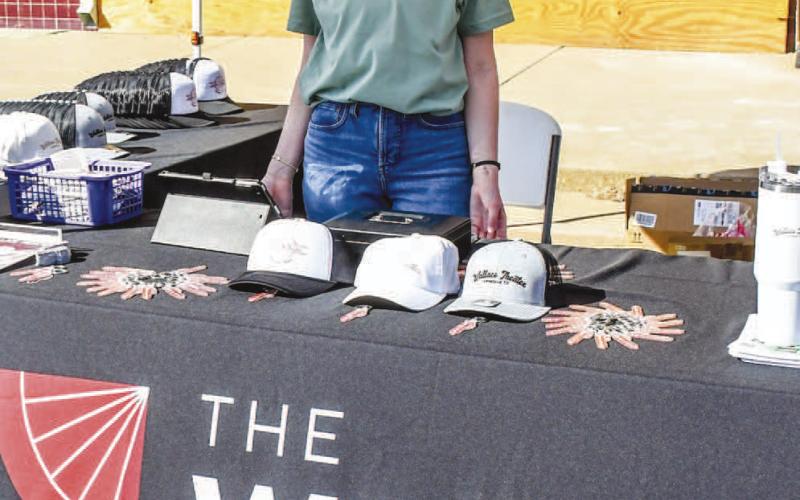 THE WALLACE THEATER – Nicole Campbell was set up outside of Wallace Theater, talking to event attendees at Saturday’s Falling for the Wallace festival in downtown Levelland. The stand featured Wallace Theater merchandise and a pumpkin ring toss game for eventgoers. (Staff photo by Evin Thomas)
