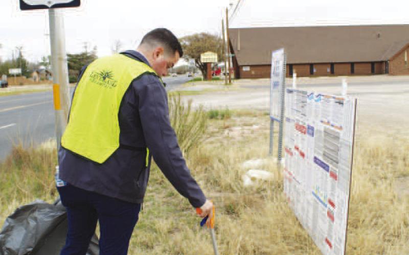 PICKING UP TRASH-- Keep Levelland Beautiful hosted a massive clean up this Saturday. Volunteers worked along Hwy. 114 cleaning up litter. (Staff photo by Shelby Radford)