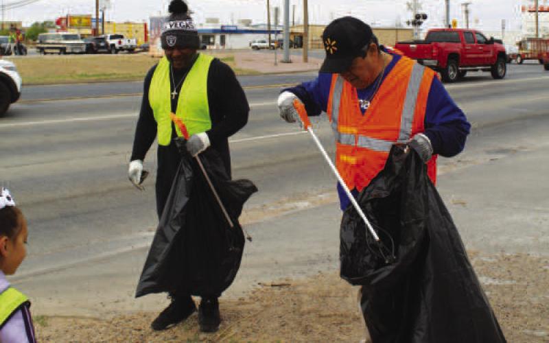 CLEANING UP-- Community members worked in chilly weather on Saturday to help clean up litter in the city. (Staff photo by Shelby Radford)