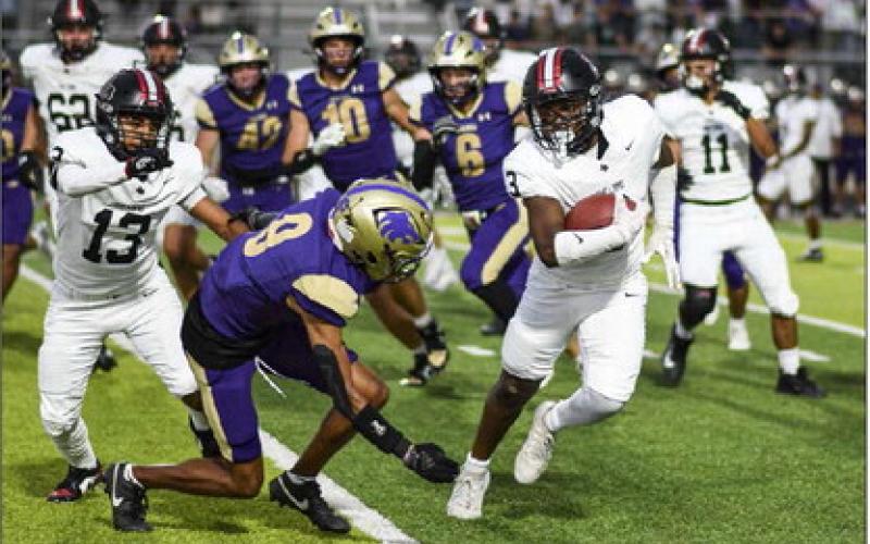 EVADE THE DEFENSE – Sophomore running back Noah Martin evades the defender as he rushes the football during a game against Dalhart this past Friday night at Memorial Stadium. (Staff photo by Jentezen Smith)