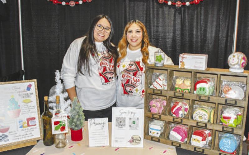 COOKIE STAND – Pictured are Monica Herrera and Victoria Guajardo with The Sugared Flamingo stand, selling decorated sugar cookies to Fa La La attendees, Dec. 12 in Levelland. (Staff photo by Evin Thomas)