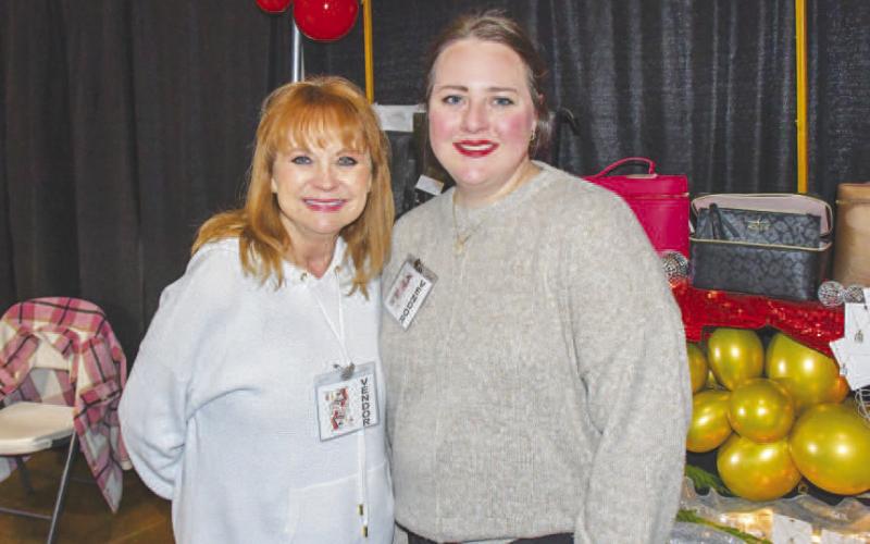 READY TO SELL – Patti Osborn and Jessica Tucker worked as vendors for Levelland’s Fa La La event Dec. 12, selling items to attendees that browsed around the Mallet Event Center and Arena banquet hall area. (Staff photo by Evin Thomas)