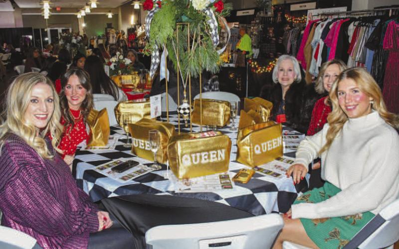 QUEEN CIRCLE – The Broken Spur table group smiled with their golden ‘QUEEN’ bags gifted to them for Levelland’s Fa La La event Dec. 12. (Staff photo by Evin Thomas)