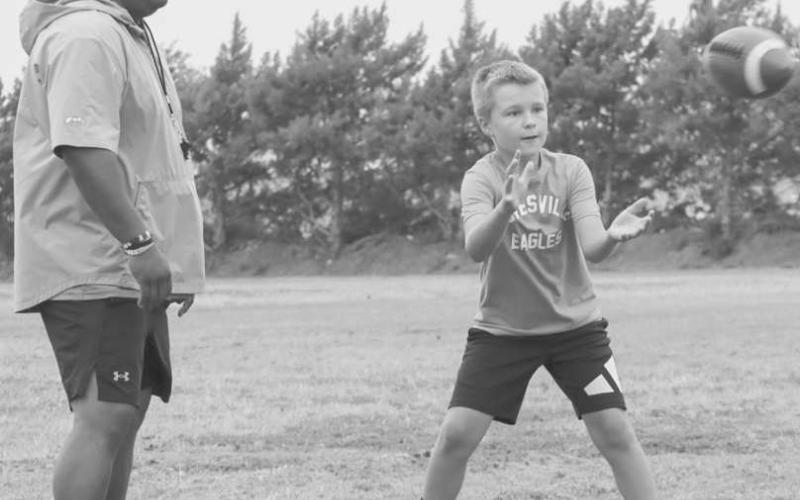 CURLS - Tate Schilling caught the ball on a curl route in front of Ropes Coach Nathan Flores this past Monday at the Ropes Football Field during the Ropes Eagle Football Camp. (Staff photo by Aalijah Soliz)
