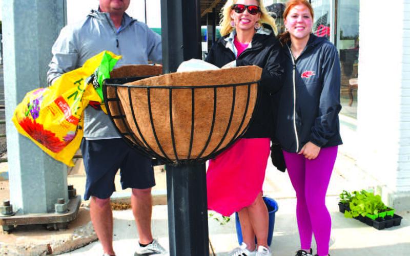 COMMUNITY PLANTING DAY - On Saturday, the Levelland Main Street Program held their annual Community Planting Day event with volunteers picking a planter around the downtown area to adopt. Pictured is Matt, Breanna and Mattie Buxkemper. (Staff photo by Emily Campos)