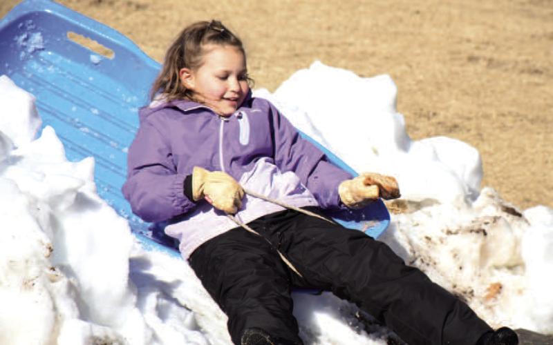 SIBLING COMPETITION - Piper Williams made use of her sled time racing her brother Tyler at the sled hill at Lobo Hill in Levelland, Thursday. With different trials, her favorite was the most difficult hill that had the most speed. (Staff Photo)