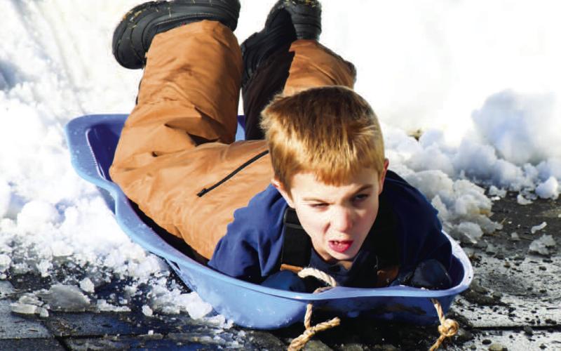 PURE SPEED - Atticus Reichelt was getting in his sled time at Lobo Hill Thursday afternoon. The sled hill was open to the public from Thursday through Saturday. (Staff Photo)
