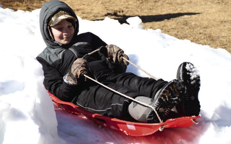 AFTER SCHOOL FUN - Tyler Williams was one of the first sled riders at Lobo Hill Thursday afternoon. Getting to go down the different trails, Williams got plenty of sled time. (Staff Photo)