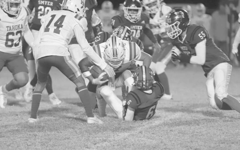 TAKE DOWN - Smyer Bobcats Max Benevedes and Hagen Cooper brought down the Tahoka runningback this past Friday night during the team’s last game of the season. (Photo courtesy of Daniel Paredes)