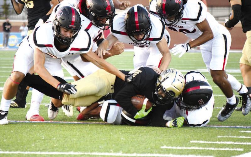 TEAM EFFORT- The Levelland Lobos fell to 0-3 after a Thursday loss against the Lubbock High Westerners 21-14 on the road in Lubbock. The Levelland defense is pictured making a group tackle. The Lobos will welcome the Estacado Matadors in to town for homecoming next Friday. (Staff Photo by Dom Puente)