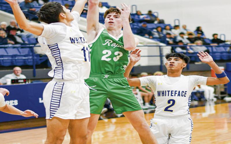 CONTESTED FLOATER - Ropes Eagle Cutter Stumbo shoots a floater as Whiteface Antelope Cesar Chavez contests the shot during their district basketball game this past Tuesday at Whiteface High School. Stumbo would score 18 points in the game. (Staff photo by Jentezen Smith)