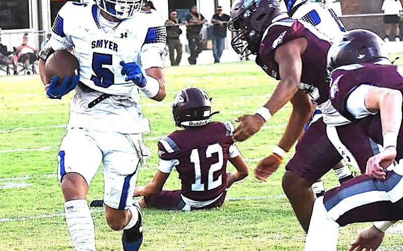 Smyer Bobcat Noah Gonzales carries ball in game against the Ralls Jackrabbits during last Friday’s game. (Smyer ISD photo)