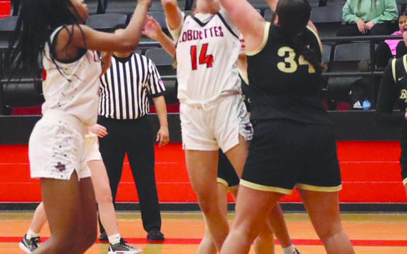 TOUGH OFFENSE - Levelland Loboette Kaylee Penner shot the ball through contact from the Big Spring defense during the teams win last week in the district opener. (Staff photo by Aalijah Soliz)