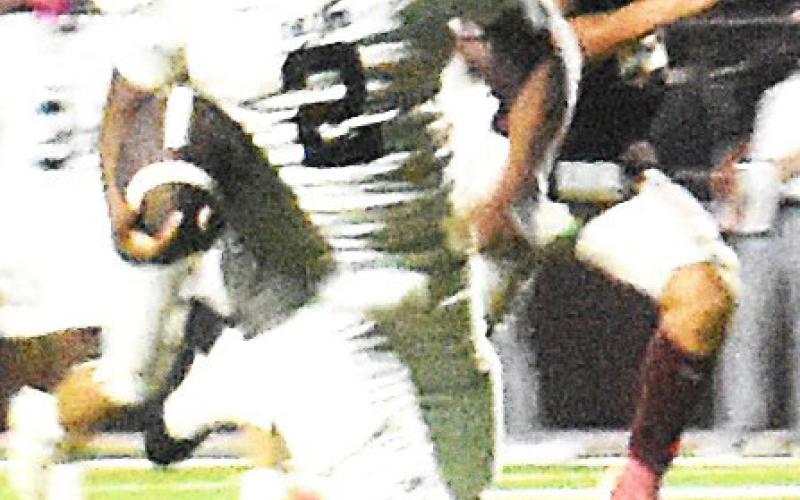 Above photo: Lobo defense bringing down Littlefield offense. (staff photo) Left photo: Lobo Noah Martin on a ball carry against Littlefield. (staff photo)