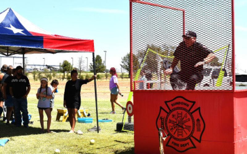 DUNK TANK – Levelland Fire Chief Brian Horton falling into a tank of water as part of a fundraiser for the Levelland Police Department’s Blue Santa event in December.
