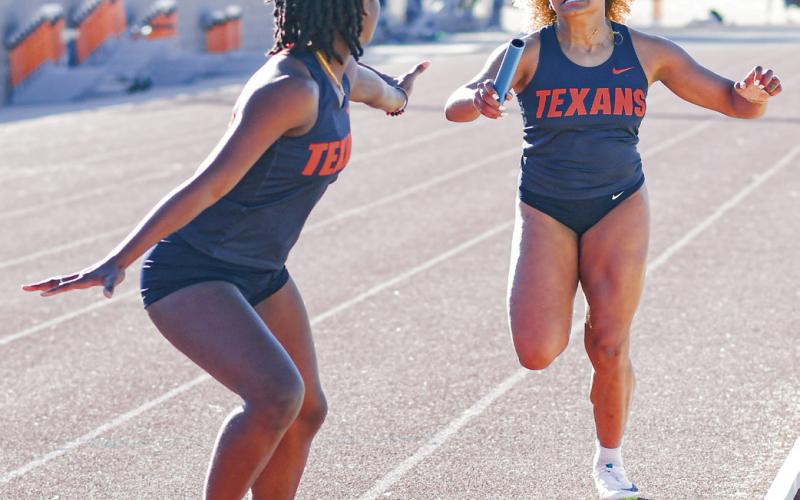 PURE PAIN - South Plains College’s Shahyna Coudriau finishes her leg of the 4x400-meter relay and hands the ba - ton off to her teammate Cheffonia Houston at the SPC West Texas Shootout this past Saturday at the South Plains College track facility. (Staff photo by Jentezen Smith)
