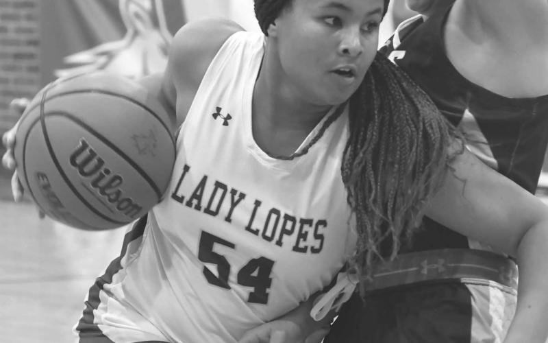 STRONG DRIVE - Timmyah Olenga blew past a defender in a 39-29 Whiteface Lady Lopes win over the Plains Cowgirls last Saturday in the girls’ championship of the Whiteface Way Out West High School Basketball Tournament. The Lady Lopes are fifth in the Texas Association of Basketball Coaches’ Class 1A poll. (Staff photo by Jay Kelley)
