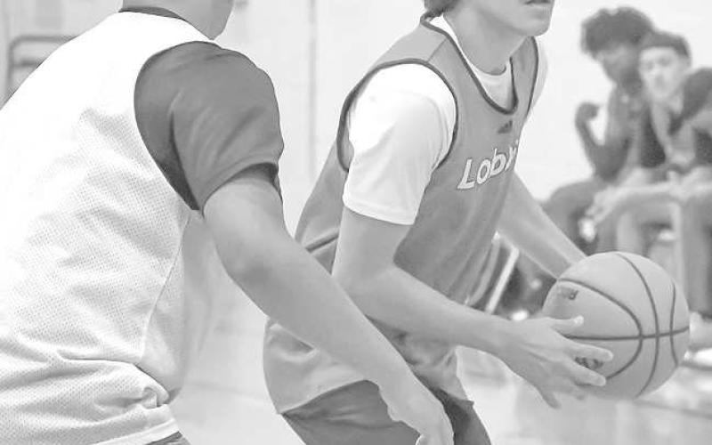 LOOKING TO PASS- Levelland Middle School hosted summer league basketball games Thursday. The Lobos rolled out the welcome mats for Olton and Littlefield. Lobo Jose Muro pulled down an offensive rebound and looked for an open teammate to pass the ball to during the Lobos’ match-up with Littlefield. (Staff Photo by Aalijah Soliz)