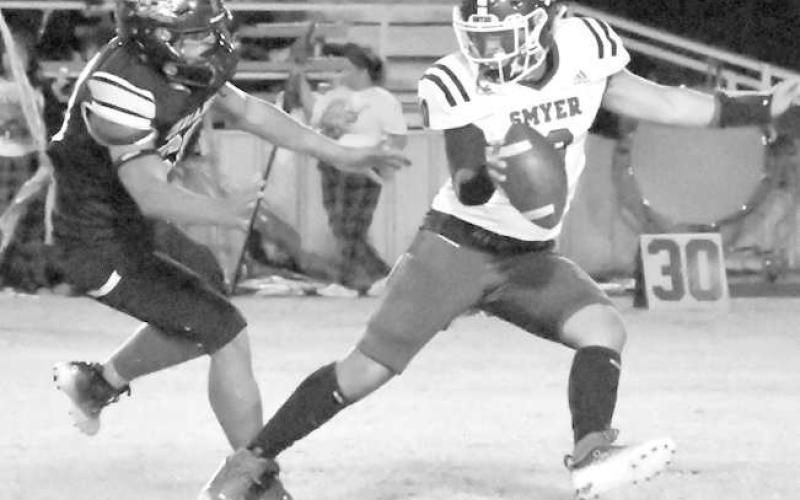 ESCAPING A SACK- Peyton Casillas went 6-for-13 for 115 yards and three interceptions for the Smyer Bobcats in a 24-12 road win over the Morton Indians last Friday in UIL high school football action. Smyer will host Seagraves on Friday while Morton hosts New Home. Games start at 7 p.m.(Photo Courtesy of Jay Kelley)