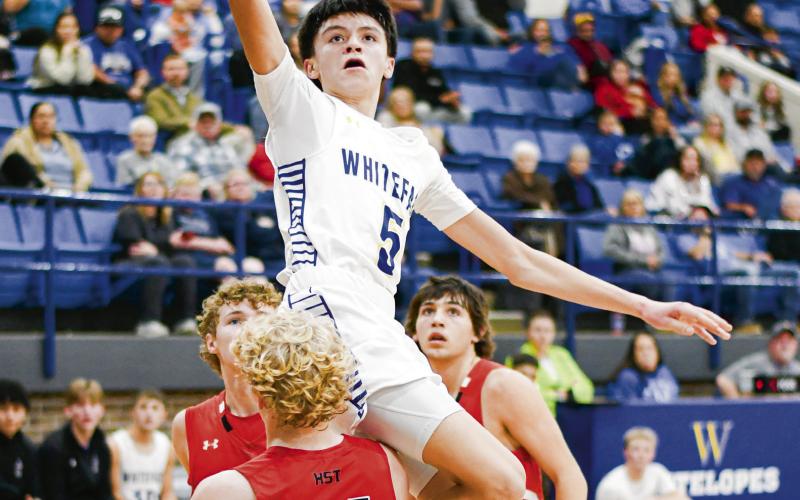 GANDARA WITH THE FLOATER - Whiteface Antelope Ivaniel Gandara lays up a floater while trying to evade contact with a New Home defender during their game this past Tuesday night in Whiteface. Gandara would score 12 points in the loss. (Staff photo by Jentezen Smith)