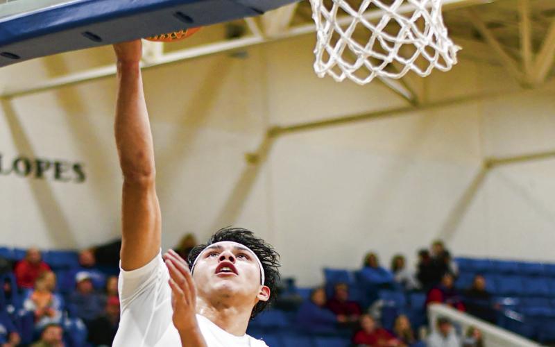 FOURTH QUARTER TAKEOVER - Whiteface Antelope Isaak Soliz goes up for a layup during their home game against New Home this past Tuesday night. Soliz would go off for 11 points in the fourth quarter and nearly lead a comeback. (Staff photo by Jentezen Smith)