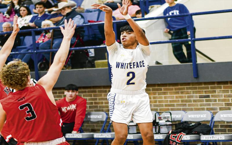 THREE-POINT THREAT - Whiteface Antelope Victor Borunda lets one loose from three-point range during their home game against New Home this past Tuesday night. (Staff photo by Jentezen Smith)