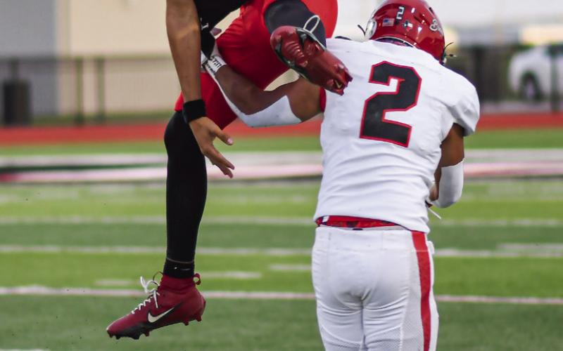 QB1 HURDLE - Levelland junior starting quarterback Ethan Salazar hurdles the Brownfield defender this past Friday night during their Homecoming football game. (Staff photo by Jentezen Smith)