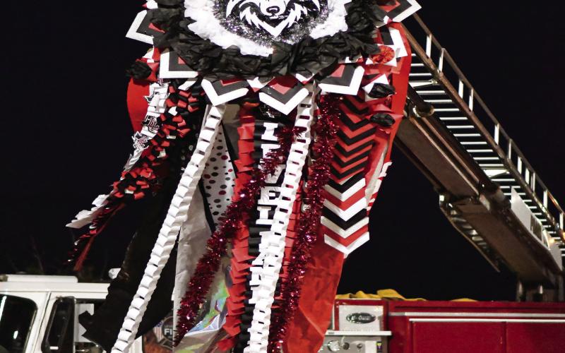 HOMECOMING MUM - The Levelland Fire Department hoists the Homecoming Lobos mum this past Friday night during the game against Brownfield. The Lobos would win the football game 50-0. (Staff photo by Jentezen Smith)