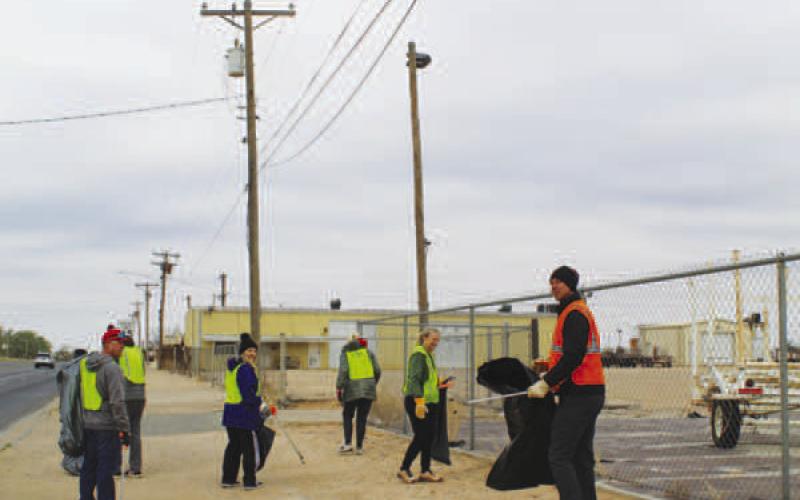 CLEANING UP-- Several volunteers worked Saturday picking up litter along Hwy. 114. (Staff photo by Shelby Radford)